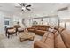 Open-concept living room features a leather sofa, modern furnishings, and a seamless flow to the dining area and kitchen at 2445 Hidden Creek Rd, Kennesaw, GA 30152