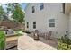 A beautiful outdoor patio area featuring a stone grill, seating, and a warm fire pit at 2445 Hidden Creek Rd, Kennesaw, GA 30152