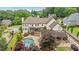 Gorgeous aerial view of backyard oasis with a sparkling pool, outdoor kitchen, and meticulously maintained landscaping at 615 Lovinggood Trl, Woodstock, GA 30189