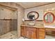 Elegant bathroom featuring a vanity, granite countertop, and glass-enclosed shower at 615 Lovinggood Trl, Woodstock, GA 30189