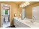 Bathroom with double sinks and ample cabinet space. The commode is adjacent at 615 Lovinggood Trl, Woodstock, GA 30189