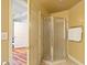 Bathroom featuring a glass-enclosed shower with a neutral tile surround at 615 Lovinggood Trl, Woodstock, GA 30189