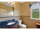 Bathroom with a vanity, granite countertop, decorative mirror, and a tiled wall at 615 Lovinggood Trl, Woodstock, GA 30189
