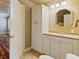 Bright bathroom with a stylish mirror, spacious vanity, and a large storage cabinet at 615 Lovinggood Trl, Woodstock, GA 30189