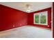 Cozy bedroom features a ceiling fan, neutral carpet and bright window view at 615 Lovinggood Trl, Woodstock, GA 30189