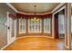 Bright dining room showcasing large windows, shutters, hardwood floors, and elegant window treatments at 615 Lovinggood Trl, Woodstock, GA 30189
