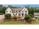 Charming two-story home with a beautifully landscaped front yard and classic architectural details at 615 Lovinggood Trl, Woodstock, GA 30189