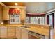 A well-lit kitchen showcasing granite counters, wooden cabinets, stainless steel appliances, and a double sink at 615 Lovinggood Trl, Woodstock, GA 30189