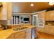 Lovely kitchen featuring granite counters, wooden cabinets, stainless appliances, and double oven at 615 Lovinggood Trl, Woodstock, GA 30189