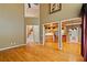 Open-concept home showcasing hardwood floors, high ceilings, and access to kitchen and staircase at 615 Lovinggood Trl, Woodstock, GA 30189