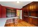 Office with built in shelves, hard wood floors, and a view to the bathroom at 615 Lovinggood Trl, Woodstock, GA 30189