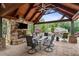 Relaxing outdoor living space with stone fireplace and dining area at 615 Lovinggood Trl, Woodstock, GA 30189