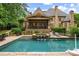 Expansive backyard featuring a pool, hot tub, and covered patio, perfect for outdoor entertaining at 816 Blackfoot Trl, Suwanee, GA 30024