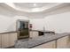 Basement bar with granite countertops, and under-counter refrigerator at 816 Blackfoot Trl, Suwanee, GA 30024