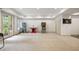 A game room in the basement with pinball machines and double glass doors for outdoor access at 816 Blackfoot Trl, Suwanee, GA 30024