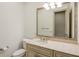 Bathroom featuring a vanity, marble counter, toilet, lighting and a large mirror at 816 Blackfoot Trl, Suwanee, GA 30024