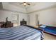 Spacious bedroom boasts a desk area and twin bed with a tray ceiling and neutral walls at 816 Blackfoot Trl, Suwanee, GA 30024
