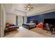 Large bedroom with a blue accent wall, a futon, and a ceiling fan at 816 Blackfoot Trl, Suwanee, GA 30024