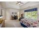 Large bedroom featuring a tray ceiling, large windows, and an aquarium at 816 Blackfoot Trl, Suwanee, GA 30024