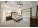 Bright and airy bedroom with large windows, tray ceiling, and soft carpet at 816 Blackfoot Trl, Suwanee, GA 30024