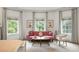 Bright bedroom sitting area with a pink velvet sofa and three large windows provides ample natural light at 816 Blackfoot Trl, Suwanee, GA 30024