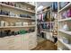 Walk-in closet with custom shelves and hanging space for clothing and accessories at 816 Blackfoot Trl, Suwanee, GA 30024