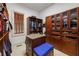 Spacious walk-in closet with wooden cabinets, shelves, and blue cushion at 816 Blackfoot Trl, Suwanee, GA 30024