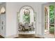 Arched doorway into a light-filled dining room, complete with elegant furnishings at 816 Blackfoot Trl, Suwanee, GA 30024