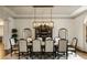 Formal dining room with a large table, seating for ten, and elegant chandelier lighting at 816 Blackfoot Trl, Suwanee, GA 30024