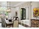Bright dining room with modern chandelier, table and seating with large arched doorway at 816 Blackfoot Trl, Suwanee, GA 30024