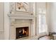 Close up view of a fireplace with decorative mantle, moldings, and hearth at 816 Blackfoot Trl, Suwanee, GA 30024