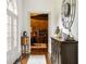 Entry hallway with front door, hardwood floors, decorative furniture, and natural light at 816 Blackfoot Trl, Suwanee, GA 30024