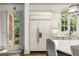 White kitchen with integrated refrigerator and doors to outside at 816 Blackfoot Trl, Suwanee, GA 30024