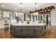 Large kitchen with central island and seating and open concept living spaces at 816 Blackfoot Trl, Suwanee, GA 30024