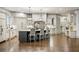 Large kitchen with island, white cabinetry, modern appliances, and hardwood flooring at 816 Blackfoot Trl, Suwanee, GA 30024