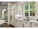 Well-lit kitchen featuring stainless steel appliances, granite countertops, custom cabinetry, and a large window at 816 Blackfoot Trl, Suwanee, GA 30024