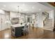 Spacious kitchen features an island with seating, wood floors, and white cabinets at 816 Blackfoot Trl, Suwanee, GA 30024
