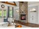 Open concept living area with stone fireplace, hardwood floors and backyard view at 816 Blackfoot Trl, Suwanee, GA 30024