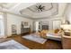 Spacious main bedroom featuring dark wood floors, a ceiling fan, and neutral colors at 816 Blackfoot Trl, Suwanee, GA 30024
