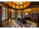 Executive office featuring dark wood paneling, custom bookshelves, and ample natural light at 816 Blackfoot Trl, Suwanee, GA 30024