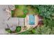 Aerial view of a private backyard pool and spa surrounded by lush landscaping and a beautiful brick patio at 816 Blackfoot Trl, Suwanee, GA 30024