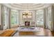Sitting area with natural light, fireplace, hardwood floors in the main bedroom at 816 Blackfoot Trl, Suwanee, GA 30024