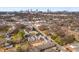 City skyline visible behind new construction townhomes surrounded by trees and streets at 1237 Memorial Se Dr # 303, Atlanta, GA 30316