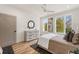 Bright bedroom with hardwood floors, dresser, and large windows for natural light at 1237 Memorial Se Dr # 303, Atlanta, GA 30316