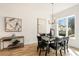 Dining area features modern decor, hardwood floors, and natural light from a large window at 1237 Memorial Se Dr # 303, Atlanta, GA 30316