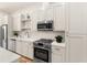 Well-lit kitchen with stainless steel appliances, white cabinets, and quartz countertops at 1237 Memorial Se Dr # 303, Atlanta, GA 30316