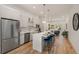 Modern kitchen featuring white cabinets, stainless steel appliances, a center island with seating, and hardwood floors at 1237 Memorial Se Dr # 303, Atlanta, GA 30316