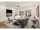 Cozy living room with hardwood floors, modern furniture, a decorative fireplace, and an abundance of natural light at 1237 Memorial Se Dr # 303, Atlanta, GA 30316