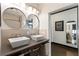 Bathroom featuring dual vessel sinks, modern fixtures, and well-lit vanity mirrors at 1300 Dekalb Ne Ave # 711, Atlanta, GA 30307