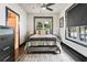 Well-lit bedroom features a modern desk, ceiling fan and access to the bathroom at 1300 Dekalb Ne Ave # 711, Atlanta, GA 30307